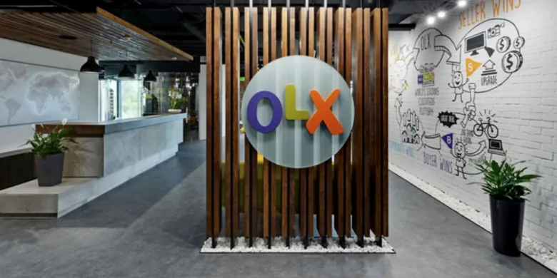 Сучасний офіс компанії OLX з великим логотипом на стіні.